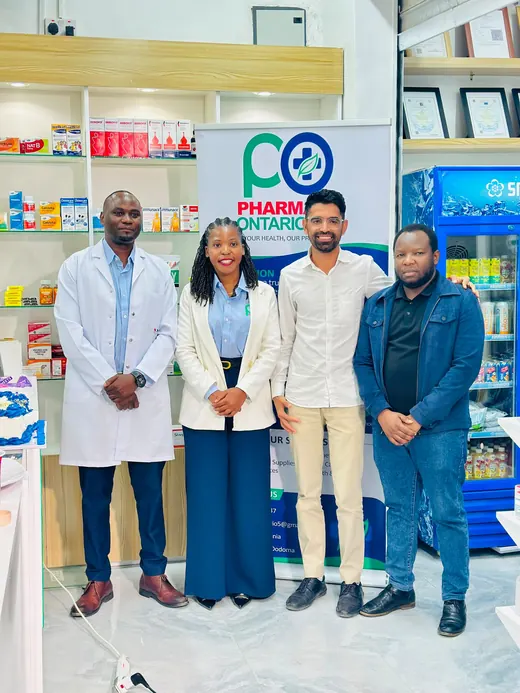 The Pharmacy Ontario team standing in front of the company banner